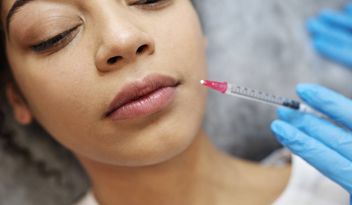 Young woman getting a lip filler